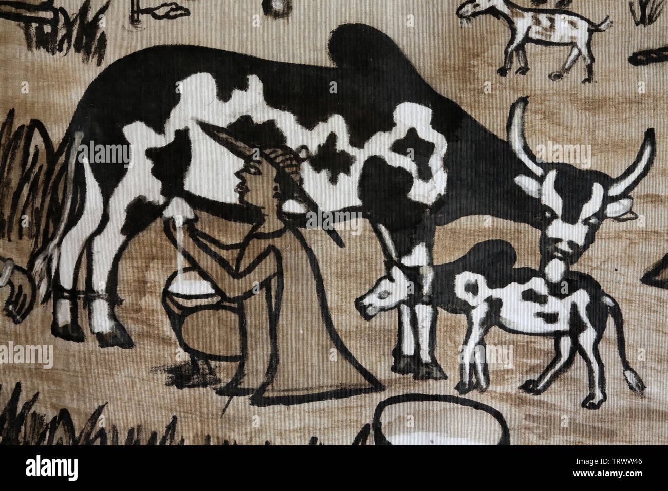 Traite d'une vache. Il Musée International du Golfe de Guinea. La convenzione di Lomé. Il Togo. Afrique de l'Ouest. Foto Stock