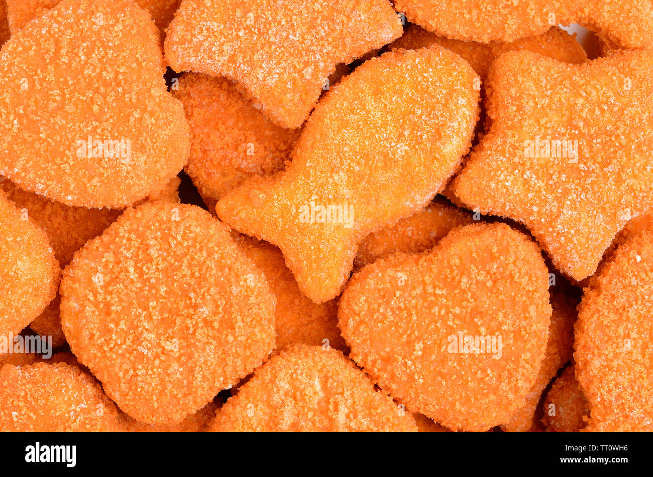 Un mucchio di pollo e pesce pepite closeup Foto Stock