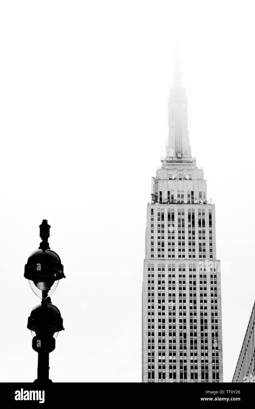 La metà superiore dell'Empire State Building con torre persa nella nebbia. In bianco e nero. Foto Stock