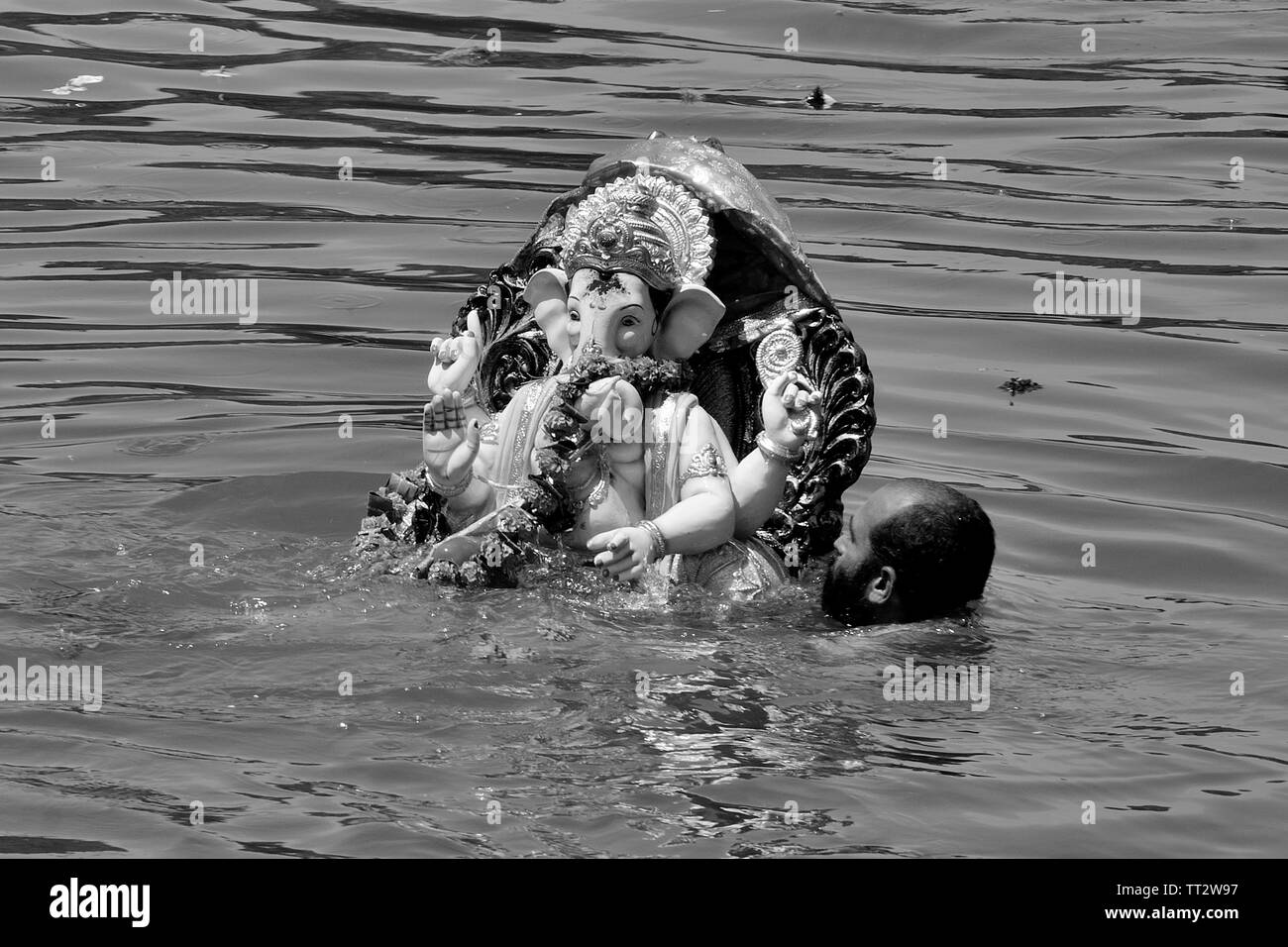 Immersione del Signore Ganesha (Ganapati Visarjan) presso la banca di fiume, Wai, Maharashtra, India Foto Stock