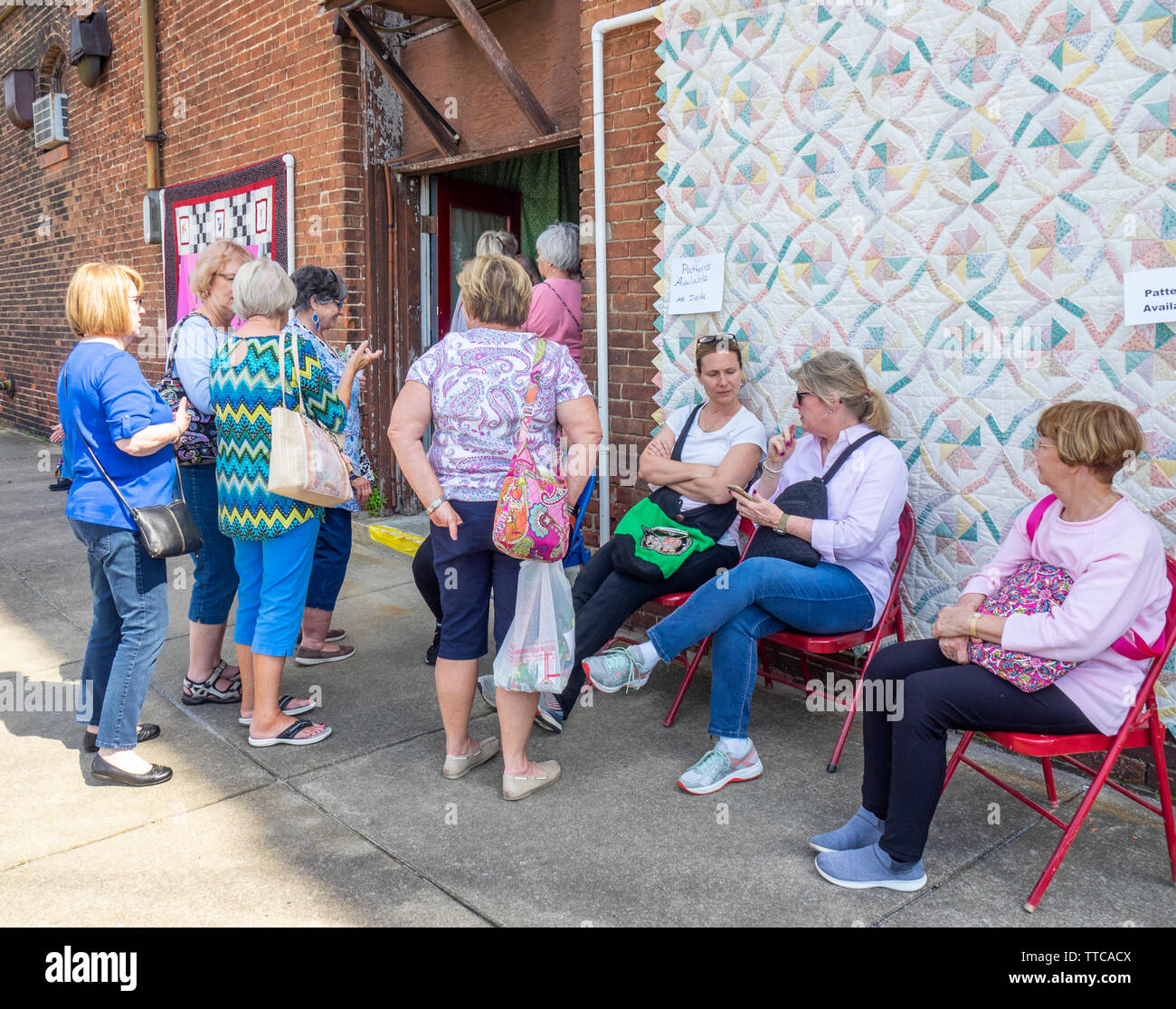 Quilters femmina acquirenti al di fuori di un negozio di tessuti durante la primavera mostra Quilt 2019 Paducah Kentucky negli Stati Uniti Foto Stock