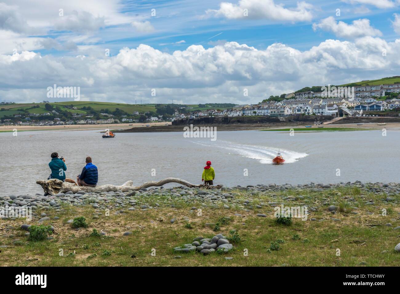 Appledore, Devon, Regno Unito. Il 16 giugno 2019. Una famiglia guarda su come il RNLI Appledore scialuppa di salvataggio set fuori dalla stazione su una chiamata al salvataggio degli occupanti di uno yacht che si sono trovate in difficoltà al largo delle coste del North Devon. Credito: Terry Mathews/Alamy Live News Foto Stock