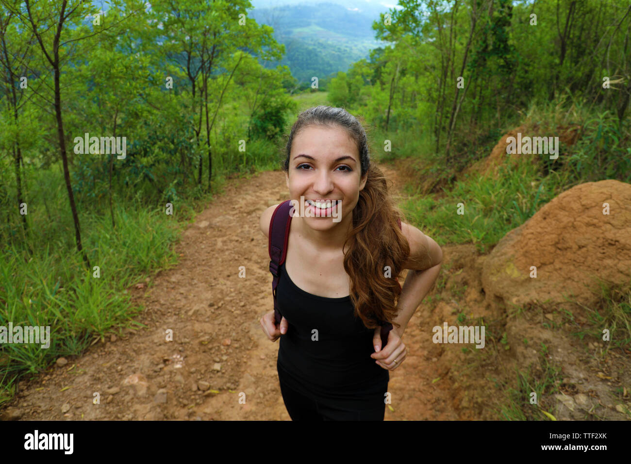 Ritratto di felice giovane donna passeggiate in mountain su Pico do Jaragua, Brasile Foto Stock