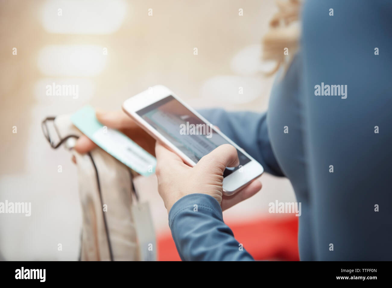 Immagine ritagliata del cliente a fotografare vestito con smart phone in boutique Foto Stock