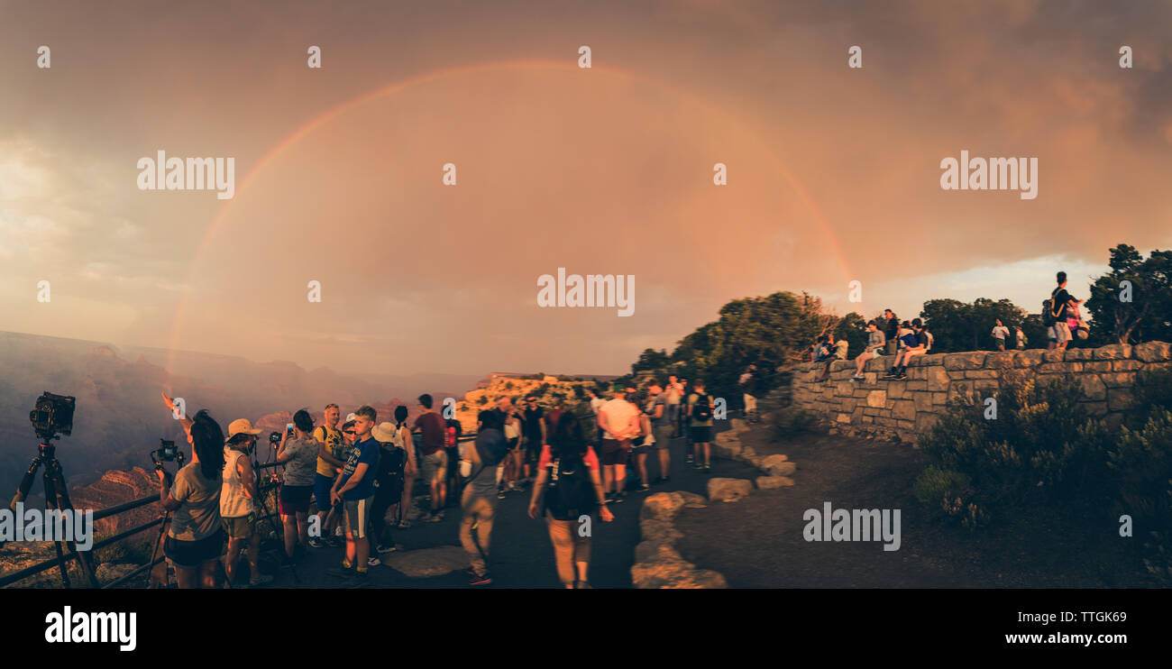 Panoramica di persone a fotografare l'arcobaleno sul Grand Canyon Foto Stock