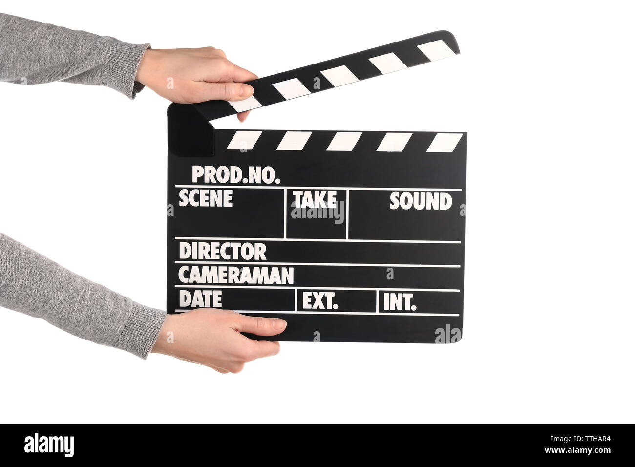 Mani femminili holding movie clapper isolato su bianco Foto Stock