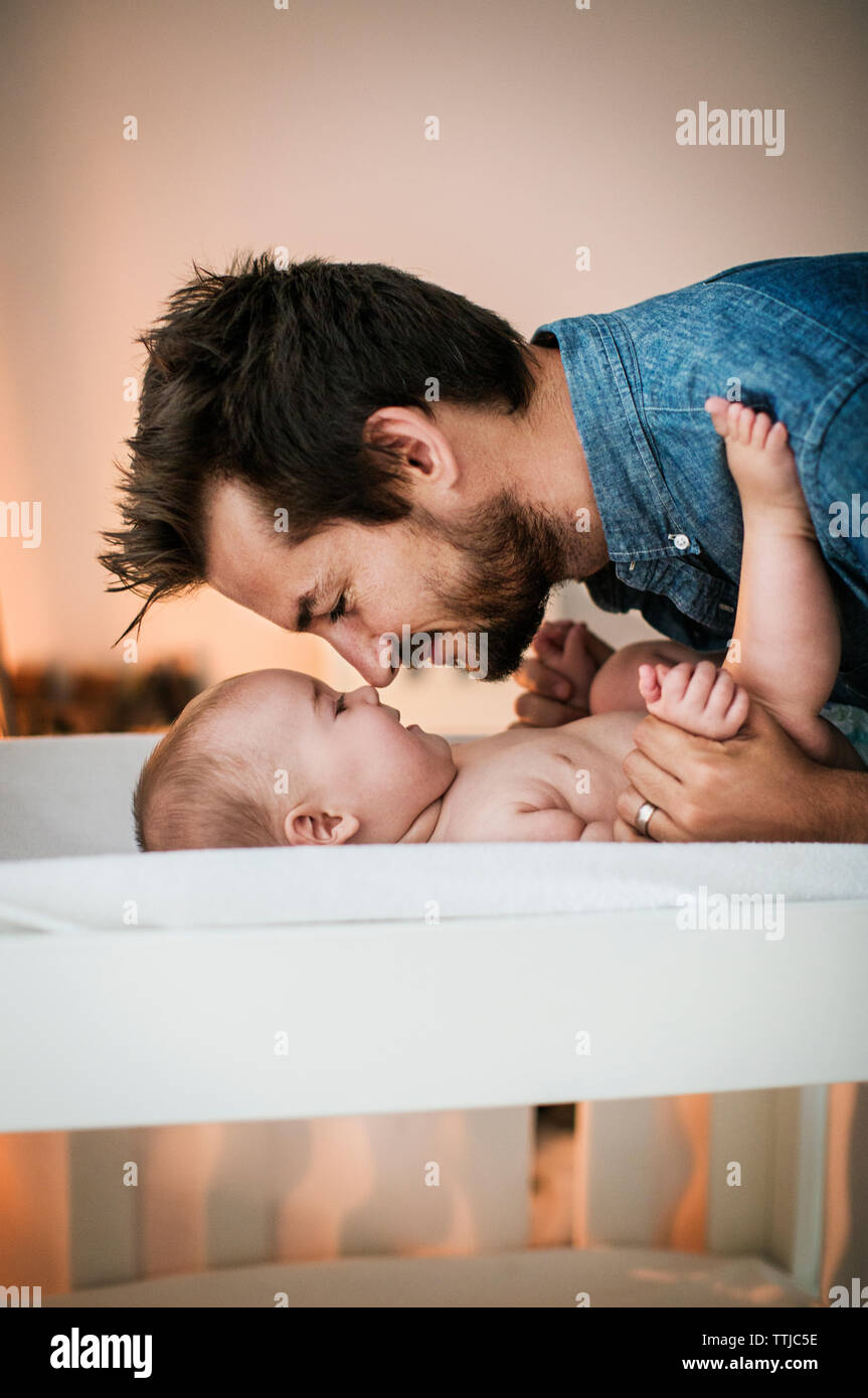 Padre strofinando il naso con il figlio a casa Foto Stock