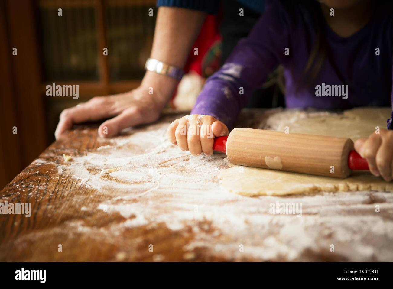 Immagine ritagliata della ragazza con la nonna preparare biscotti a casa Foto Stock