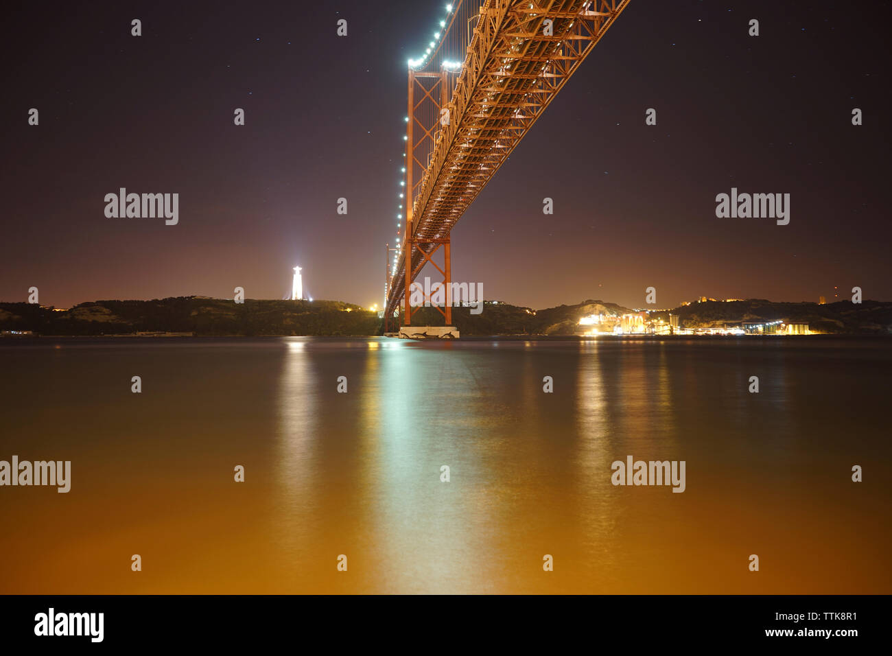Basso angolo vista del XXV Aprile ponte sul fiume Tago durante la notte Foto Stock