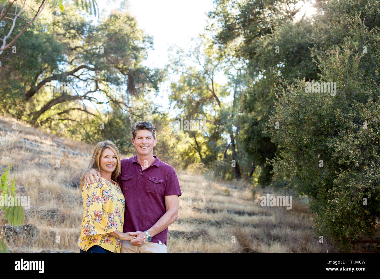Il marito e la moglie tenere mani e sorriso per un ritratto al di fuori Foto Stock