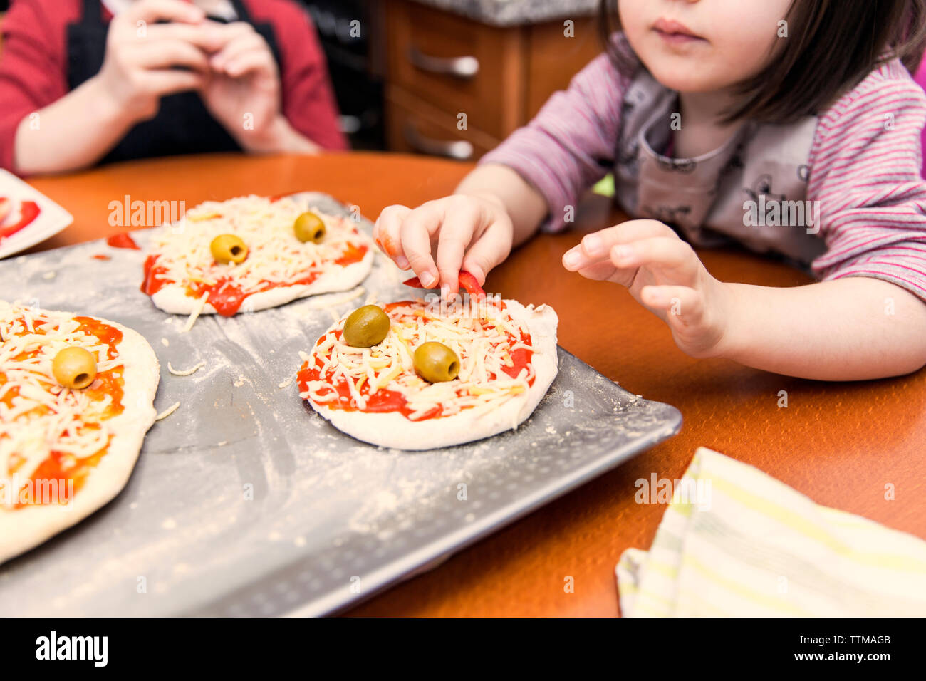I bambini preparano pizze mini Foto Stock