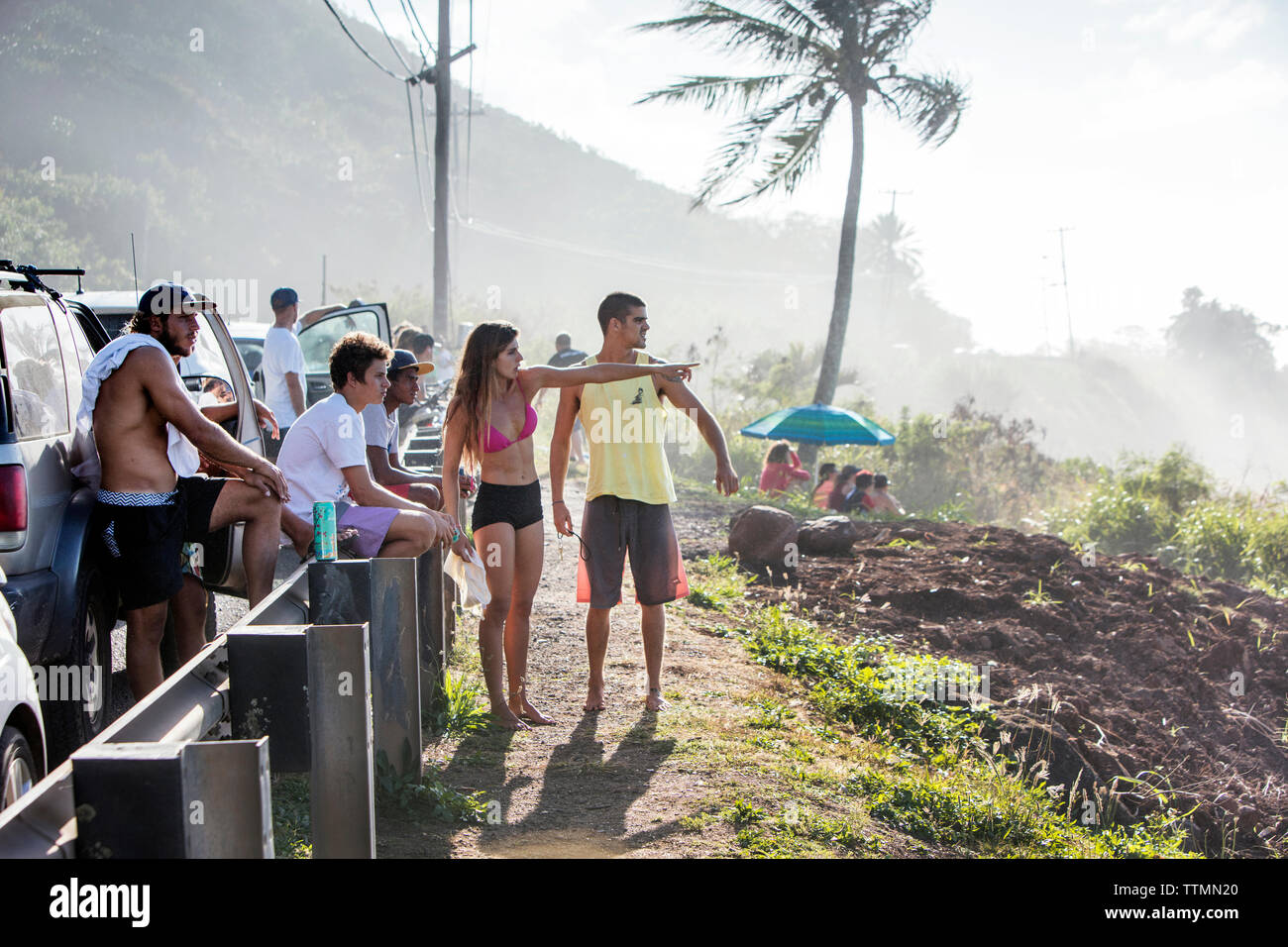 HAWAII, Oahu, North Shore spettatori guardando il grande si gonfiano le onde in rotolamento sulla sponda nord Foto Stock