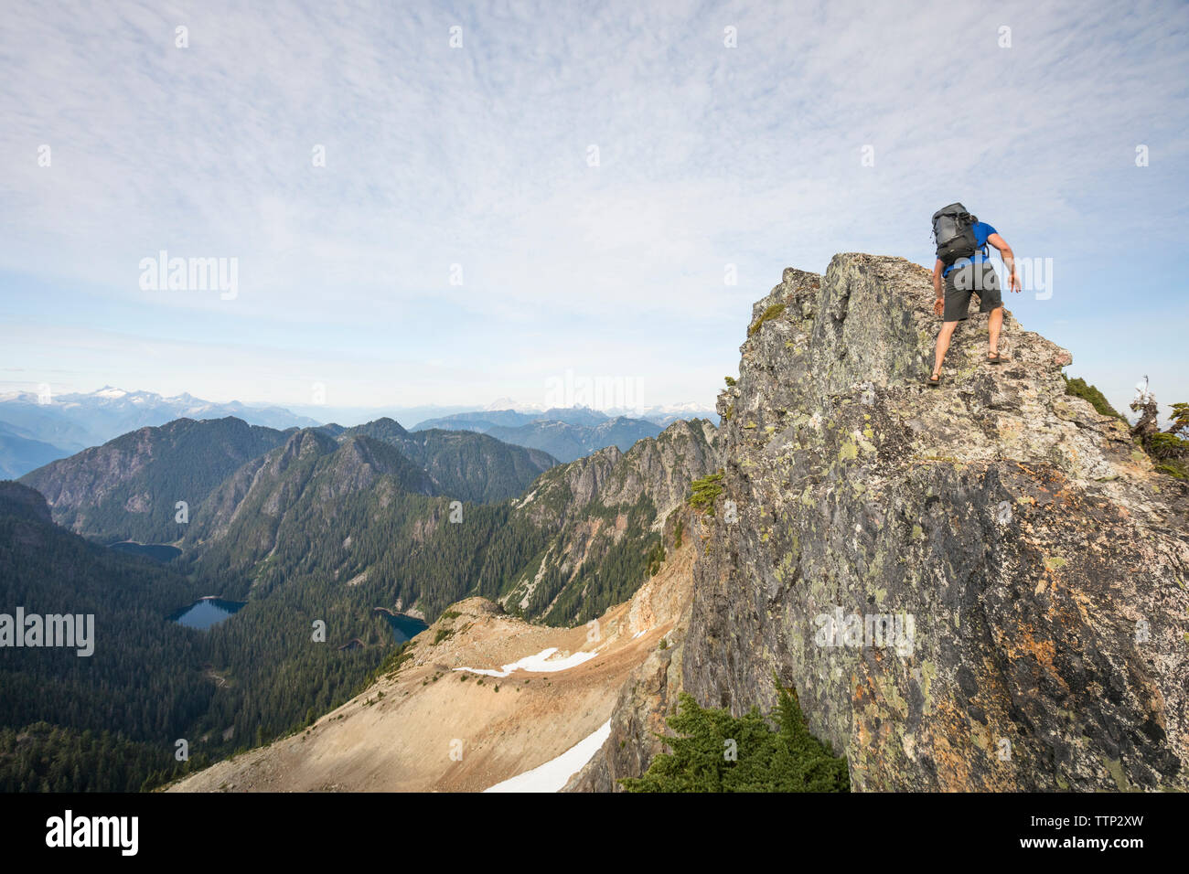 Basso angolo di visione di un escursionista salendo sulla montagna contro sky Foto Stock