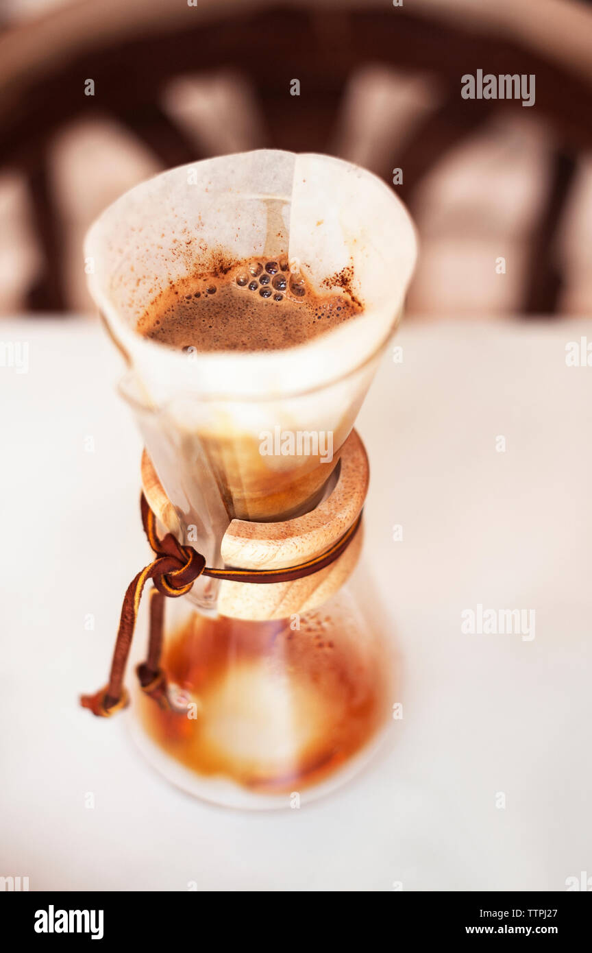 Alta vista angolare di caffè filtro e contenitore sul tavolo Foto Stock