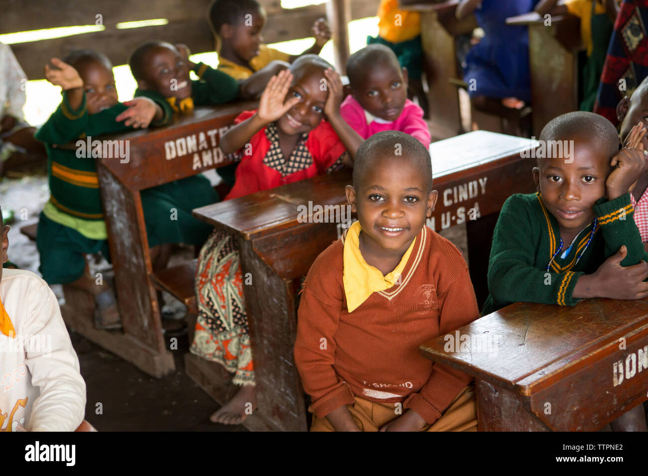 I bambini seduti alla scrivania a scuola Foto Stock