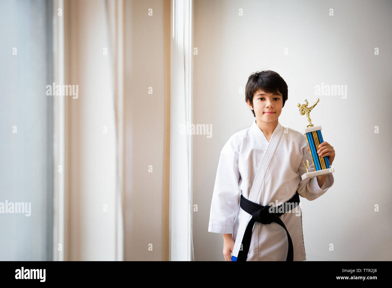 Ritratto di ragazzo holding award e di stare a casa Foto Stock