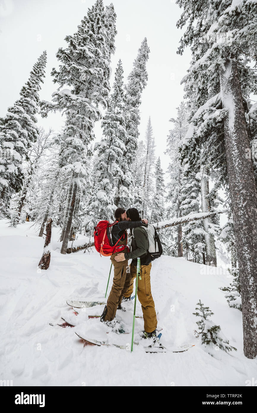 Coppia giovane abbracciare durante una sci backcountry viaggio nel Wyoming Foto Stock
