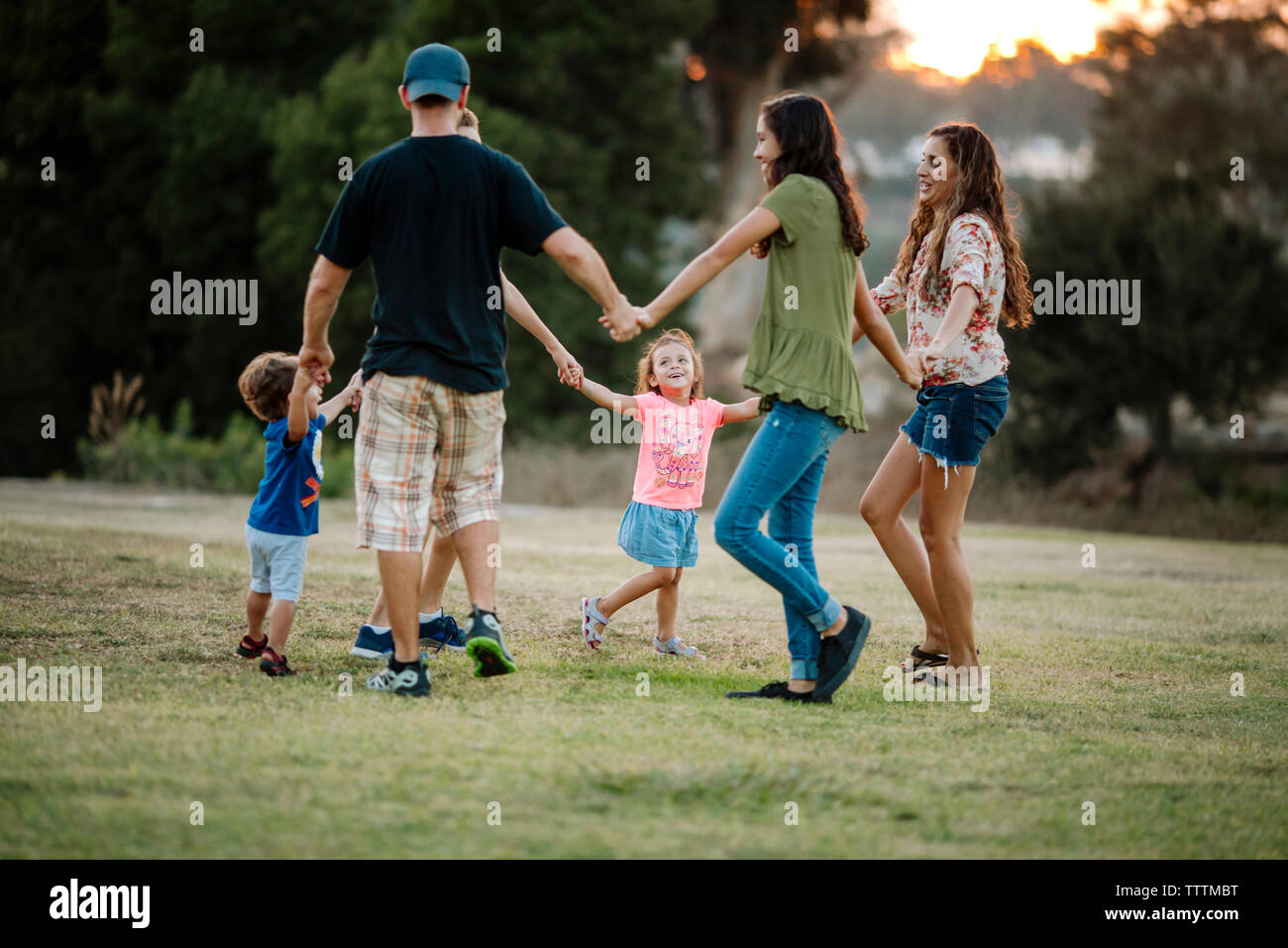 Famiglia la riproduzione ad anello attorno al Rosy a park Foto Stock