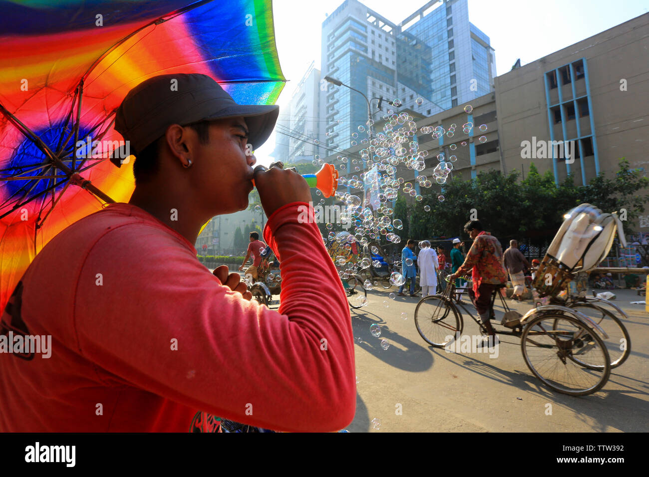 Un hawker soffiando bolle di sapone su strada in occasione di Eid ul Azha. Dacca in Bangladesh. Foto Stock