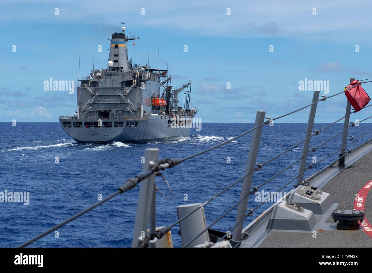 190615-N-RH019-0002 Mare delle Filippine (15 giugno 2019) Il Arleigh Burke-class guidato-missile destroyer USS Momsen (DDG 92) si avvicina alla flotta oliatore di rifornimento USNS Giovanni Erissson (T-AO 194) durante un rifornimento in mare. Momsen è distribuito negli Stati Uniti 7 flotta area di operazioni a sostegno della sicurezza e della stabilità nella regione Indo-pacifico (U.S. Foto di Marina di Massa lo specialista di comunicazione 2a classe Sean Rinner/rilasciato) Foto Stock