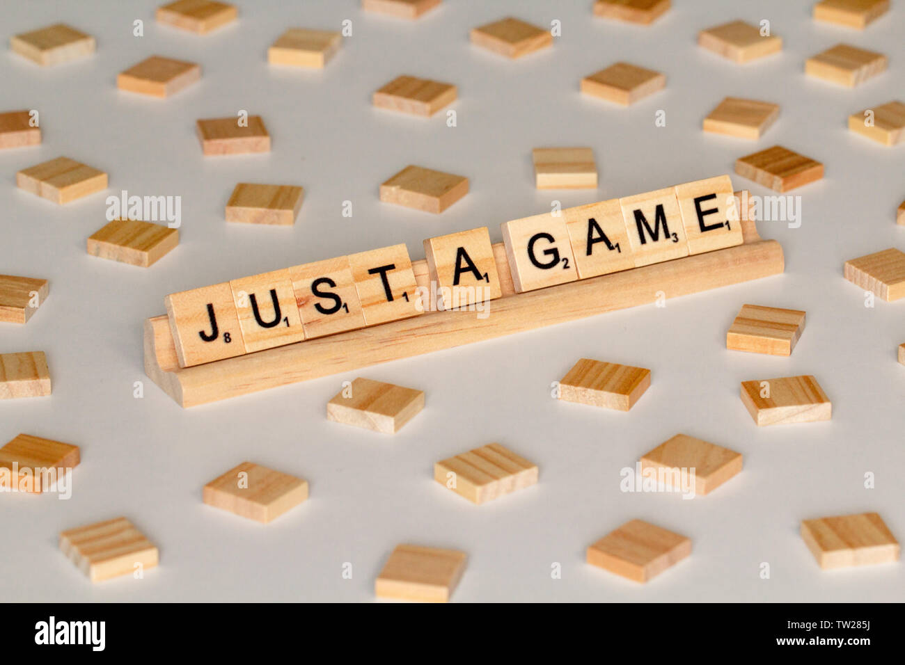 Scrabble gioco di parola piastrelle di legno ortografia 'appena un gioco' Foto Stock