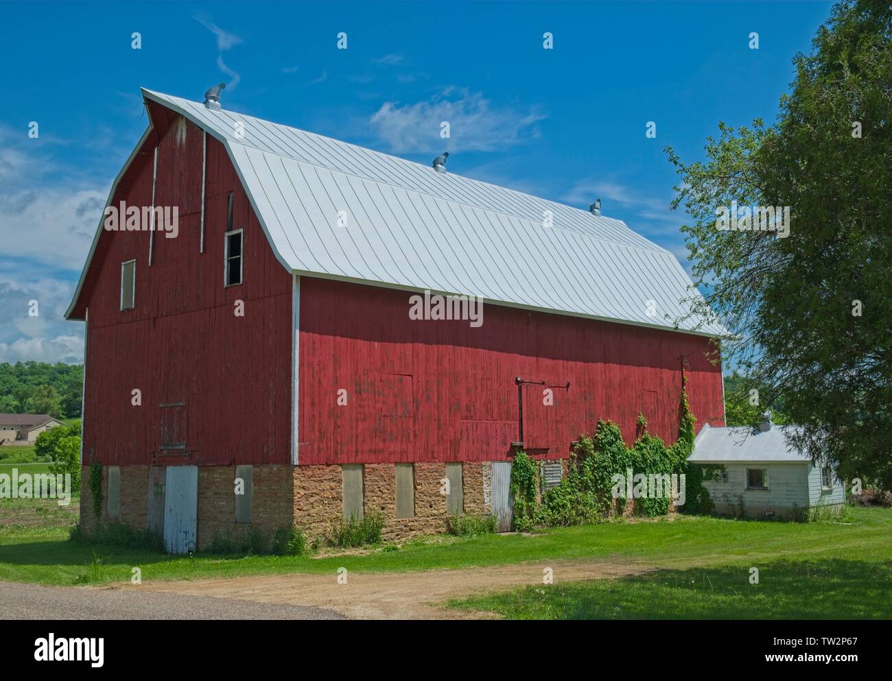 Big Red barn in una giornata di sole strada in Wisconsin rurale Foto Stock