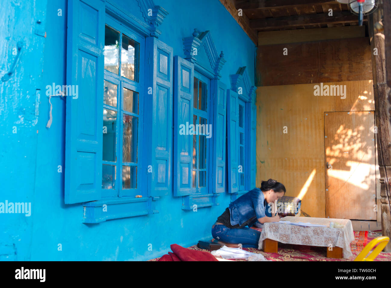 La donna nel vecchio Uighur casa nel vecchio quartiere, Yining (Ghulja), provincia dello Xinjiang, Cina Foto Stock