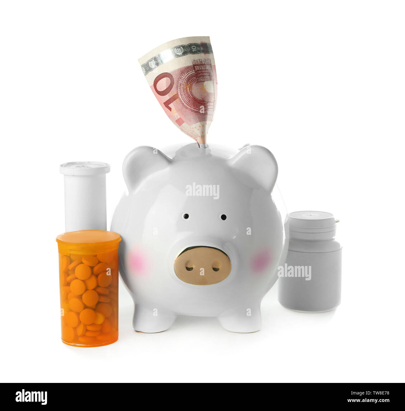 Salvadanaio con la banconota e pillole su sfondo bianco. Health care concept Foto Stock