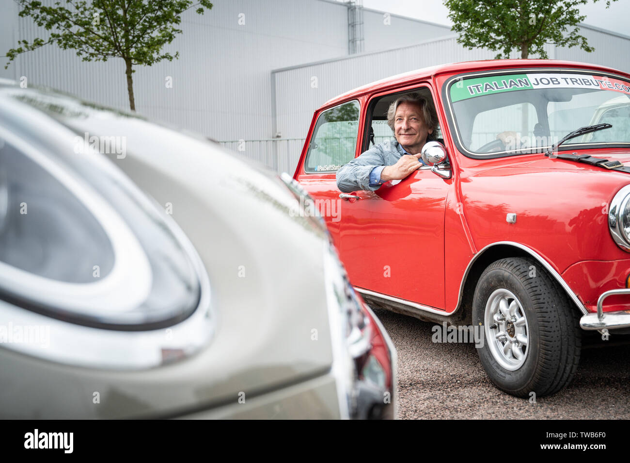 Mini impianto, Oxford, UK. 19 giugno 2019. Tributo al lavoro italiano con un display di guida e la ricreazione di soffiare le porte fuori il furgone per celebrare 60 anni di Mini e 50 anni dal rilascio del lavoro italiano film. L evento è stato frequentato da Michael Deeley Oscar produttore vincitore del film originale e David Salamone (nella foto), un stunt driver che ha giocato Domenico nel film originale nella Red mini. Andrew Walmsley/Alamy Live News Foto Stock