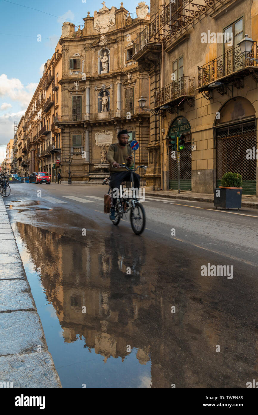 Edifici storici vicino a quatro Canti riflessa in una pozza poco dopo la pioggia, Palermo, Sicilia, Italia, Europa Foto Stock