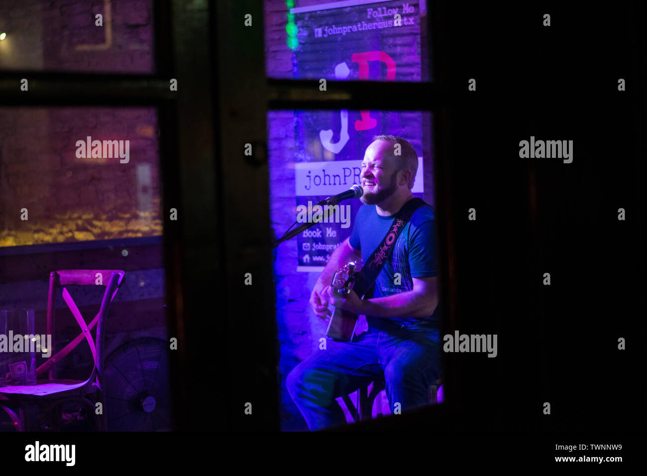 Lettore di chitarra nel centro di Austin Texas bar Foto Stock