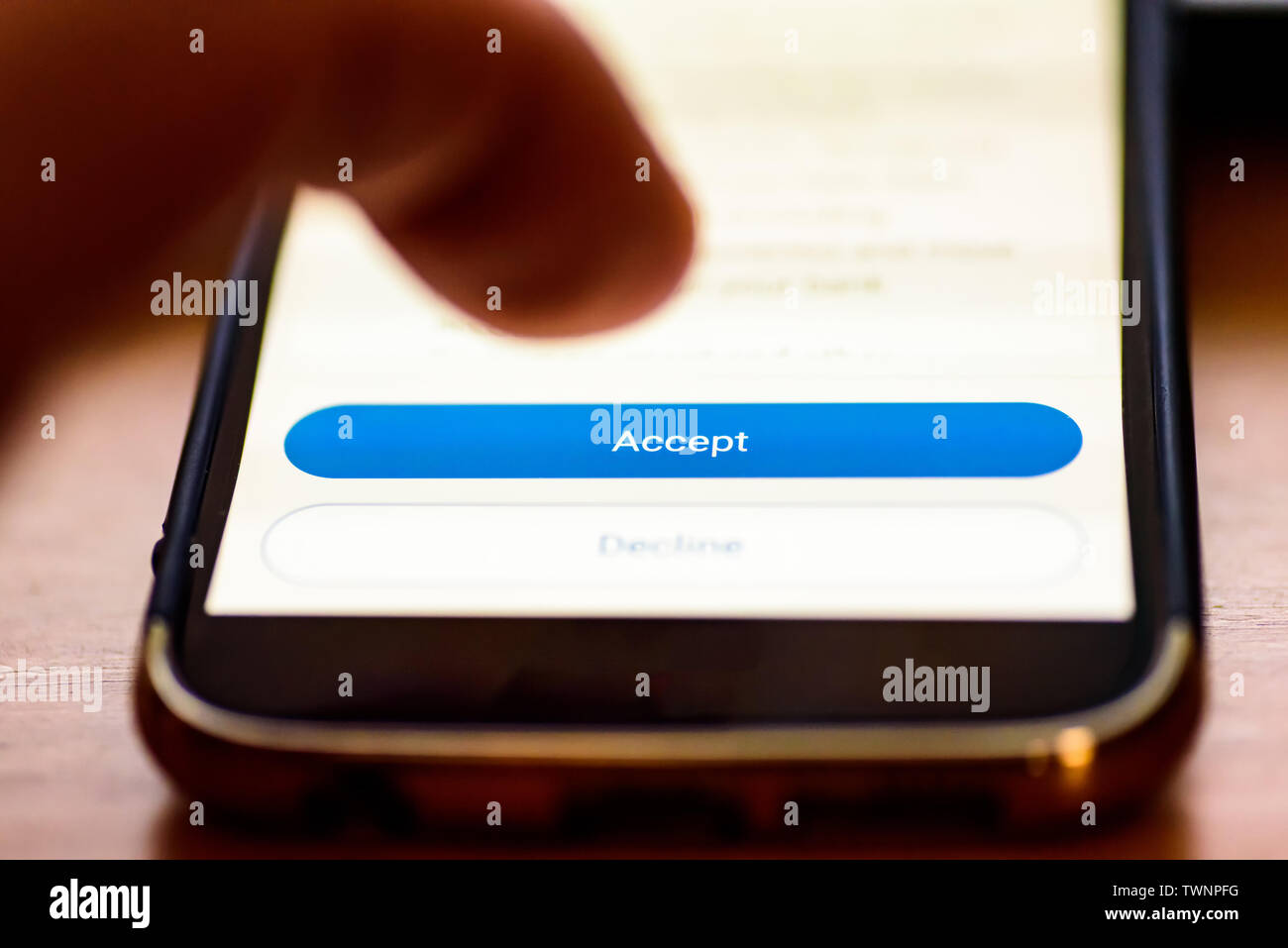 Pulsante Accetta sulla schermata dello smartphone closeup con dito umano che puntano ad esso Foto Stock