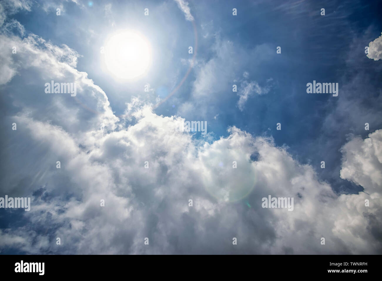 Sfondo di sole, cielo blu con nuvole bianche e luce solare luce parassita Foto Stock
