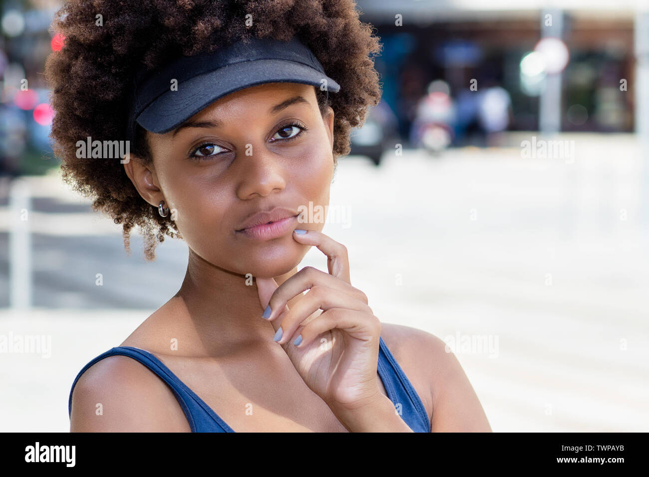 Close up ritratto di una bella americano africano giovane donna adulta all'aperto in città in estate Foto Stock