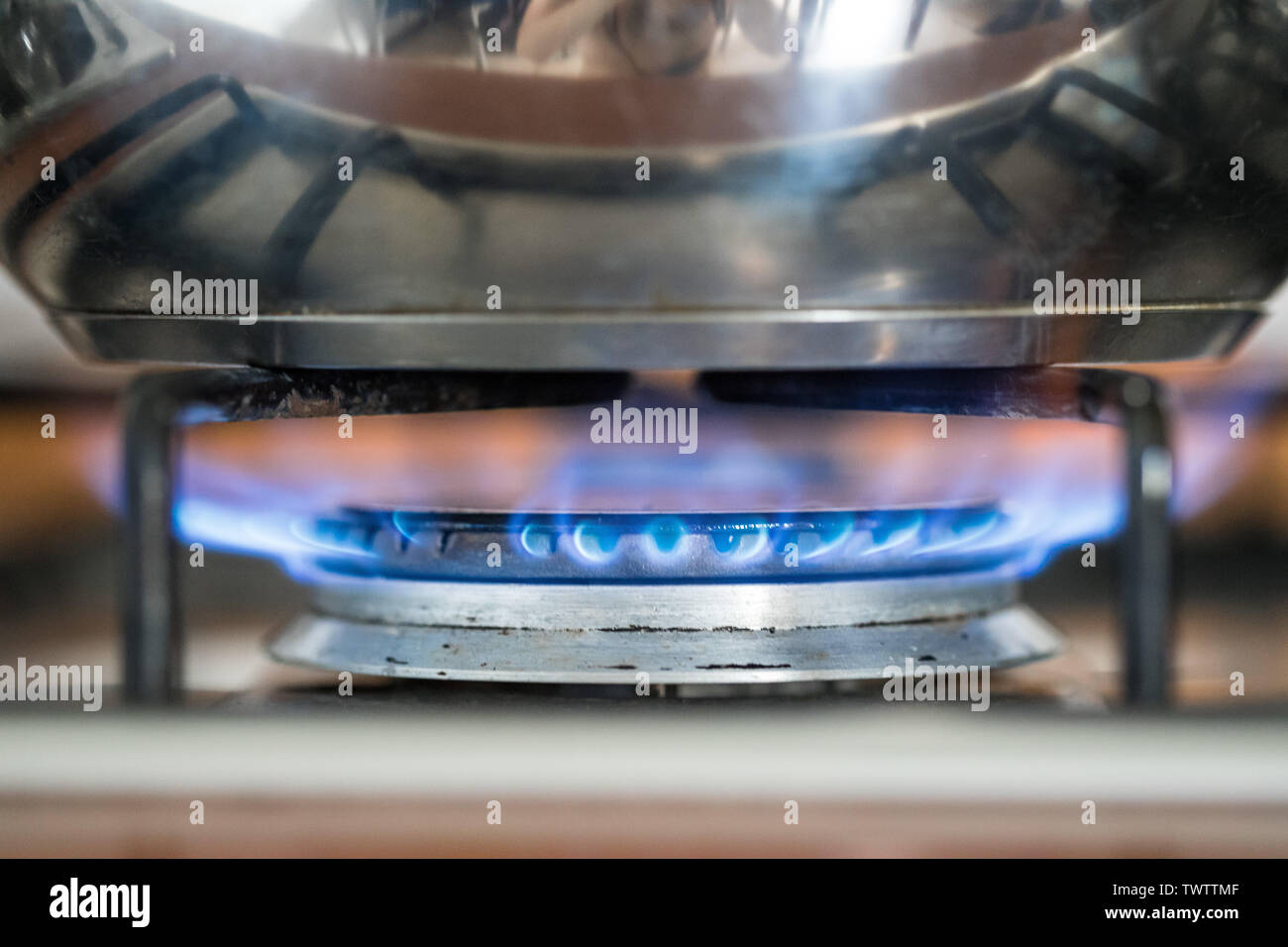 Close up di un gas blu fiamma, la cottura di una pentola di acqua in cucina Foto Stock