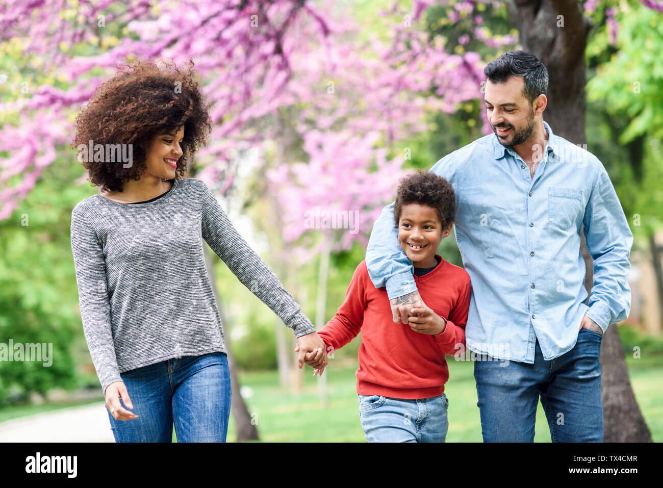 La famiglia felice a camminare in un parco Foto Stock