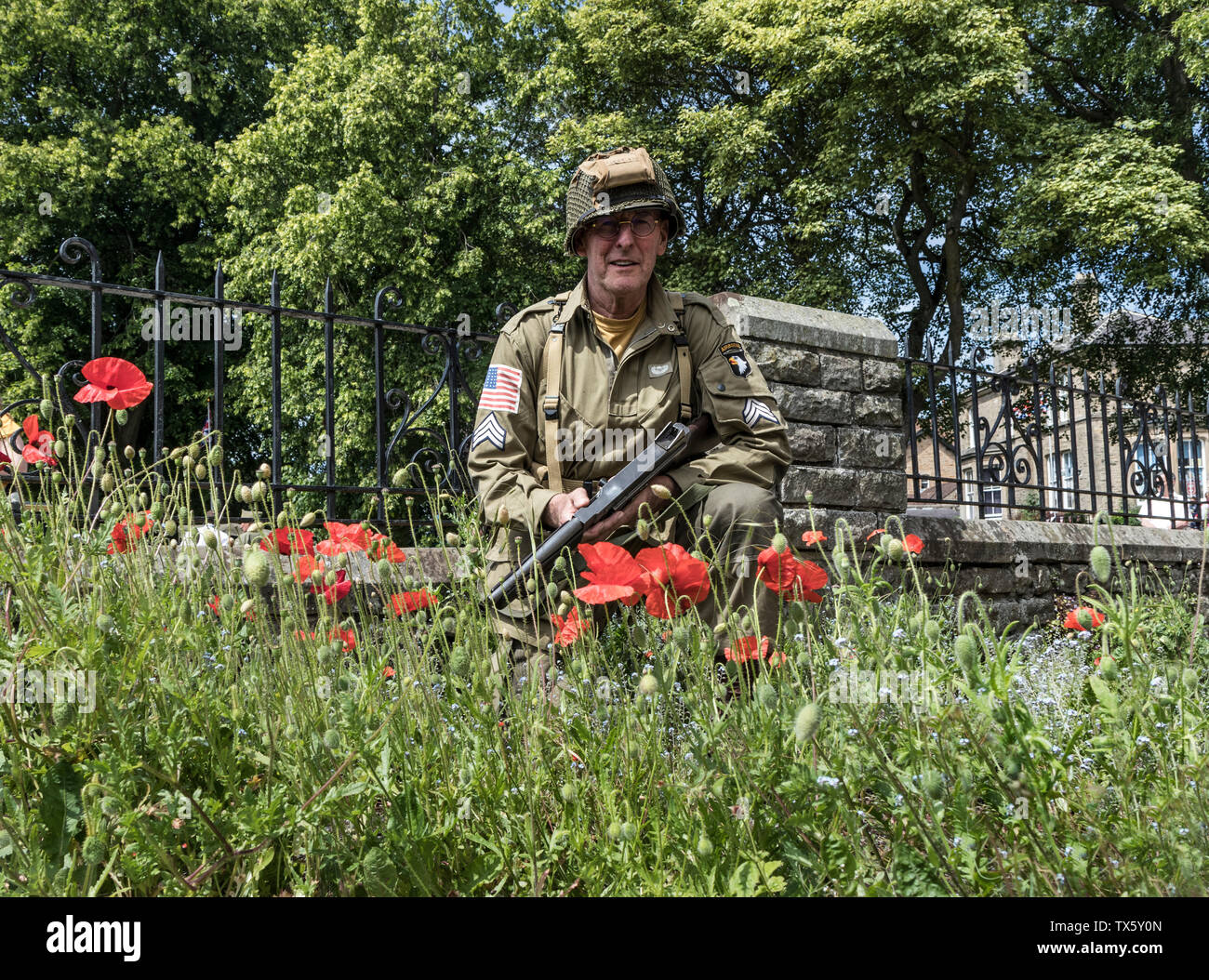 Noi Airborne Soldier (Re-Enactor) Circondato da papaveri, Barnard Castle, 1940's Weekend, 2019, Teesdale, County Durham, Regno Unito. Foto Stock