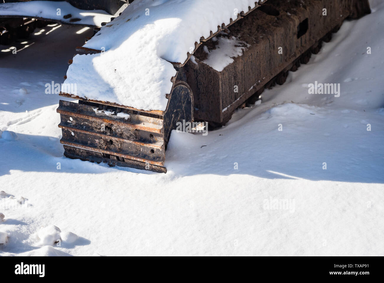 Parte di industriali pesanti tracce continua ombra di colata sulla neve. Foto Stock
