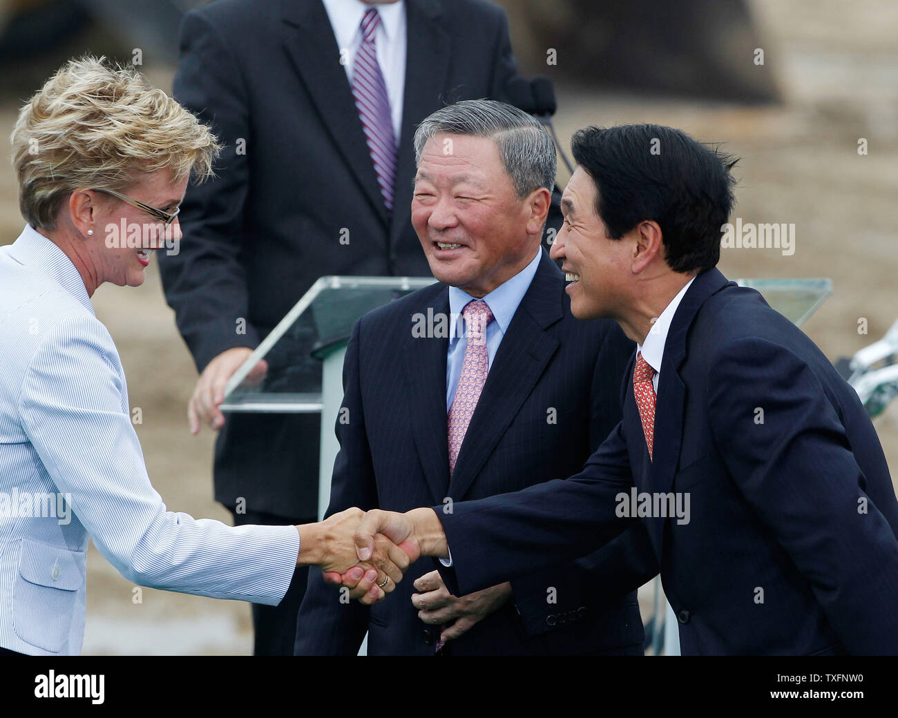 LG Presidente Koo Bon-moo (C) e LG Chem Ltd. Vice-presidente e CEO Peter Bahn-Suk Kim (R) salutare il Governatore del Michigan Jennifer Granholm a una cerimonia innovativa per una nuova batteria agli ioni di litio impianto in Olanda, Michigan, il 15 luglio 2010. Il $303 milioni di impianto gestito da LG Chem e Potenza Compatta, Inc., il cui completamento è previsto nel 2012 ed è parzialmente finanziato da un $151.4 milioni di sovvenzione dal governo federale come parte del pacchetto di stimolo. UPI/Brian Kersey Foto Stock