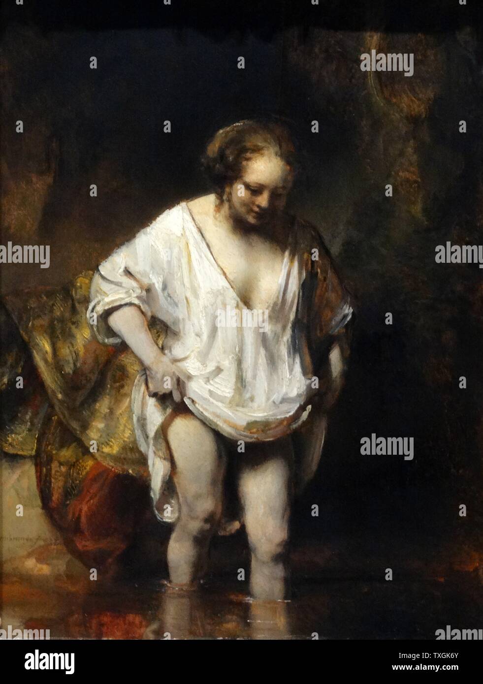 Pittura intitolata 'Una donna che faceva il bagno in un flusso' di Rembrandt Harmenszoon van Rijn (1606-1669) un pittore olandese e incisore. Risalenti al XVII secolo Foto Stock