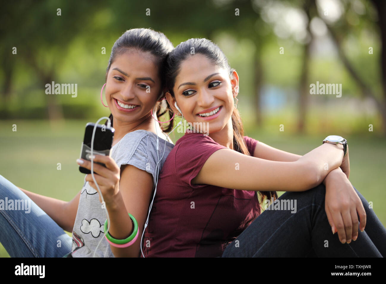 Due amici ascoltando la musica su un lettore mp3 Foto Stock