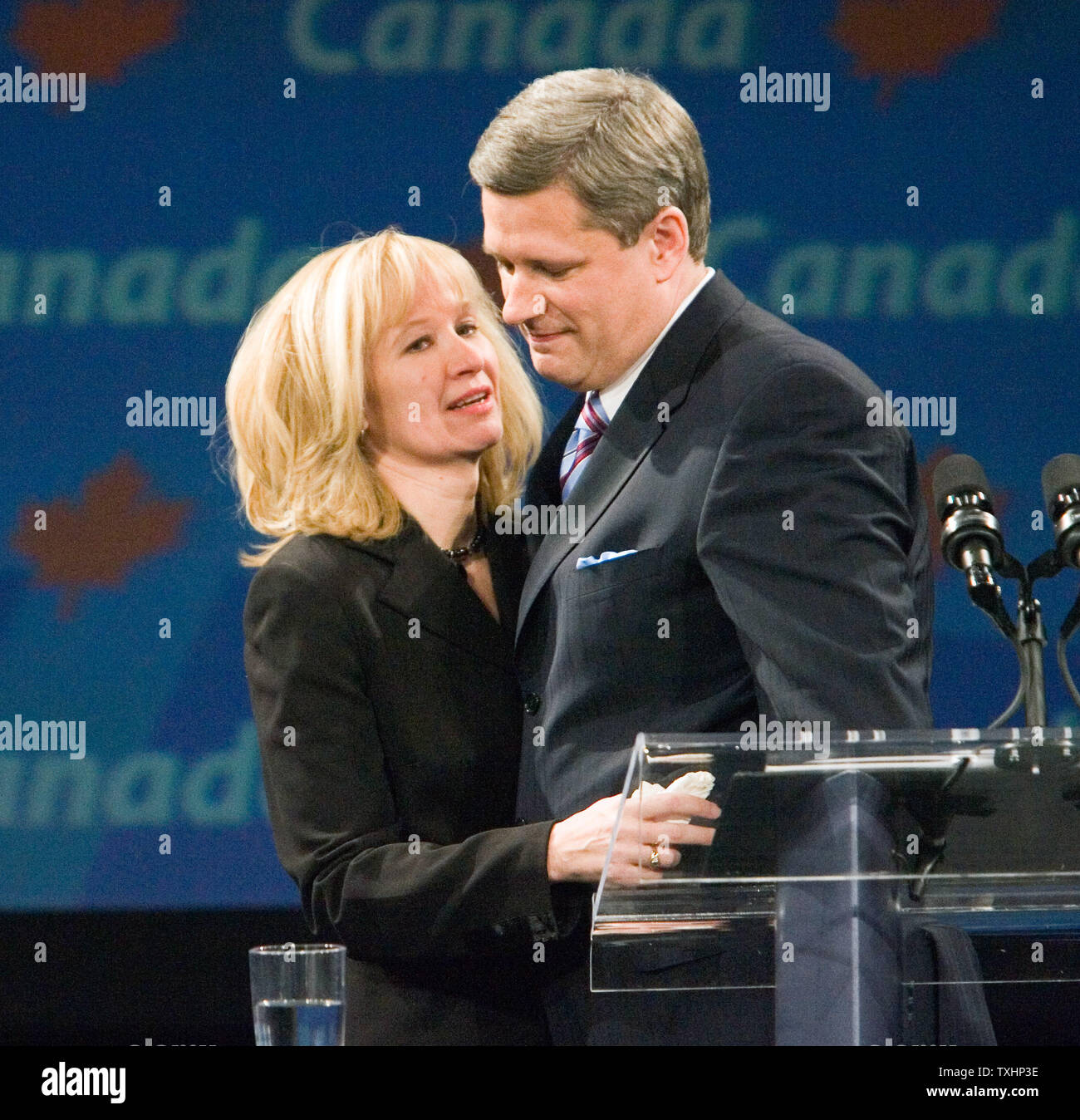 Federal leader conservatore Stephen Harper's moglie Magno con le lacrime agli occhi, abbracci il marito durante il suo discorso vittoria per i sostenitori presso la loro sede di campagna in Telus Convention Center a Calgary, Alberta dopo aver vinto il Canada elezione federale con una minoranza, 23 gennaio 2006. (UPI File foto/Heinz Ruckemann) Foto Stock