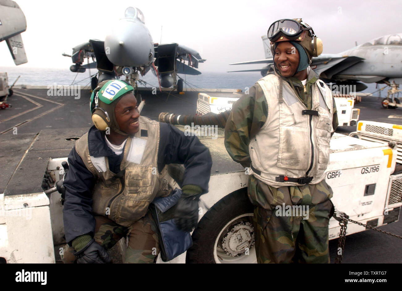 HST20030318 - a bordo della USS Harry Truman, Mediterraneo orientale, Marzo 18 (UPI)-- ADAN Michael Brevard, sinistra, di Camden, S.C. E AD1 Rufus Williams di Birmingham, Al., lo scambio di battute sul ponte di volo della portaerei USS Harry Truman Martedì, Marzo 18, 2003 nel Mediterraneo orientale. Operazioni di volo sono state sospese per il giorno a causa delle condizioni meteo. MK/jg/John Gillis UPI Foto Stock