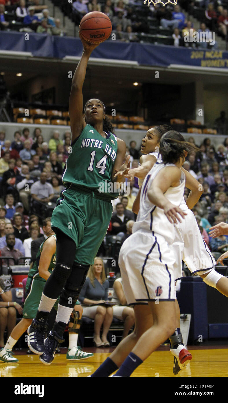 Notre Dame Fighting Irish guard Devereaux Peters (14) va per un cestino nella parte anteriore del Connecticut Huskies difensori Bria Hartley, anteriore e Maya Moore, dietro, durante la prima metà del loro NCAA finale donne quattro game al Conseco Fieldhouse di Indianapolis il 3 aprile 2011. UPI /Mark Cowan Foto Stock