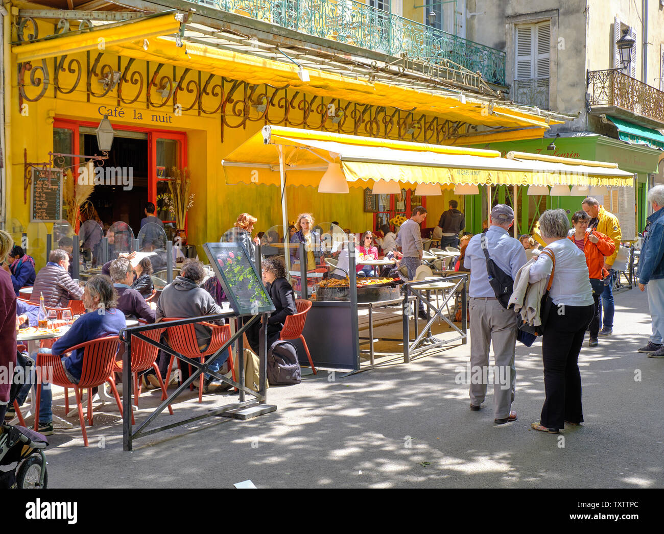 Arles, Francia: i visitatori della città di mangiare e di bere al Cafe La Nuit, reso famoso da Vincent Van Gogh dipinto 'Cafe Terrazza di Notte' Foto Stock