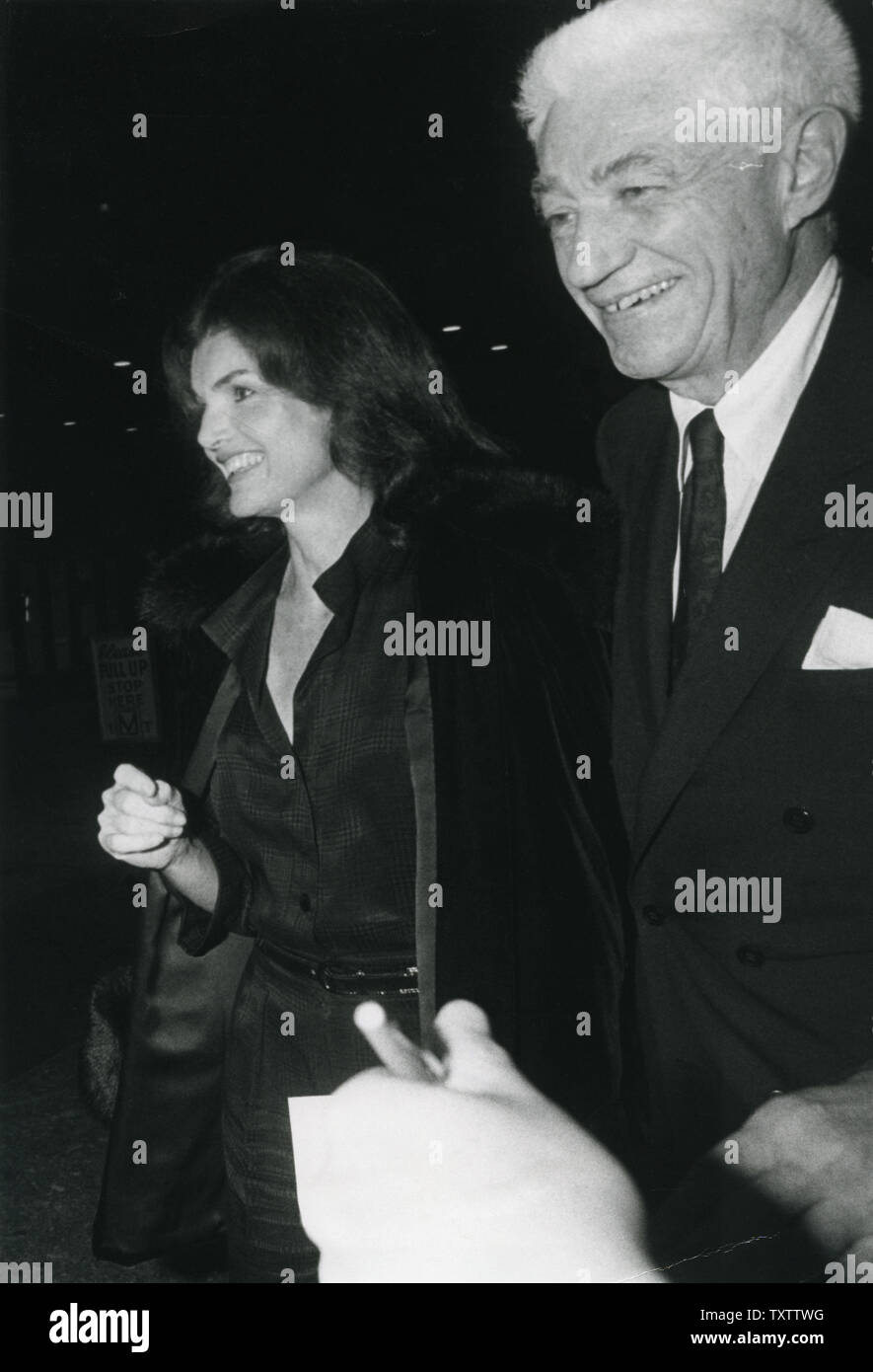 Jacqueline Kennedy Onassis e designer Oliver Smith a piedi per un teatro a New York il 9 novembre 1975. UPI Foto Stock