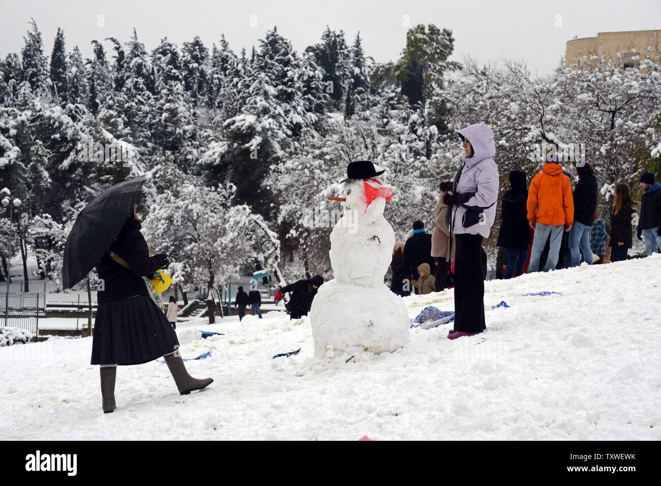 Gli israeliani costruire un pupazzo di neve in Sacher Park nel centro di Gerusalemme, Israele, 10 gennaio 2013. Gerusalemme si fermò e la chiusura di scuole e alle principali autostrade, come otto pollici di neve girato la città santa in bianco la più grande nevicata dal 1992. UPI/Debbie Hill. Foto Stock