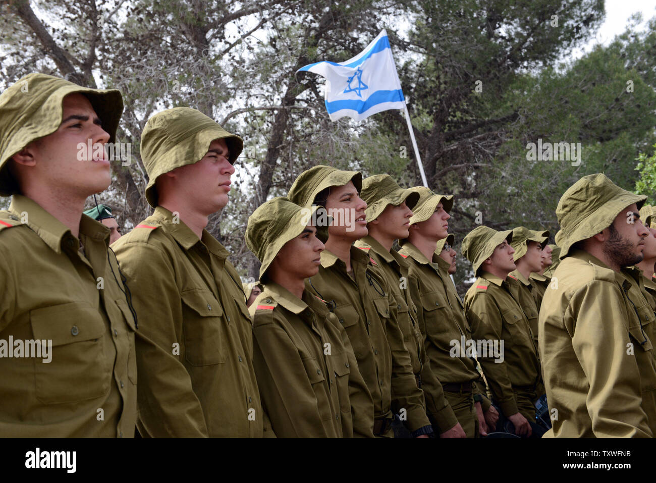 Israeliano soldati di combattimento stare in silenzio come un due minuti di sirena suona per onorare i sei milioni di ebrei che perirono sotto il regime nazista durante la Seconda Guerra Mondiale, durante un olocausto evento commemorativo sull olocausto dei martiri ed eroi' giorno del ricordo, nel martire foresta 'Scorrimento di fuoco", al di fuori di Gerusalemme, Israele, Aprile 8, 2013. UPI/Debbie Hill Foto Stock