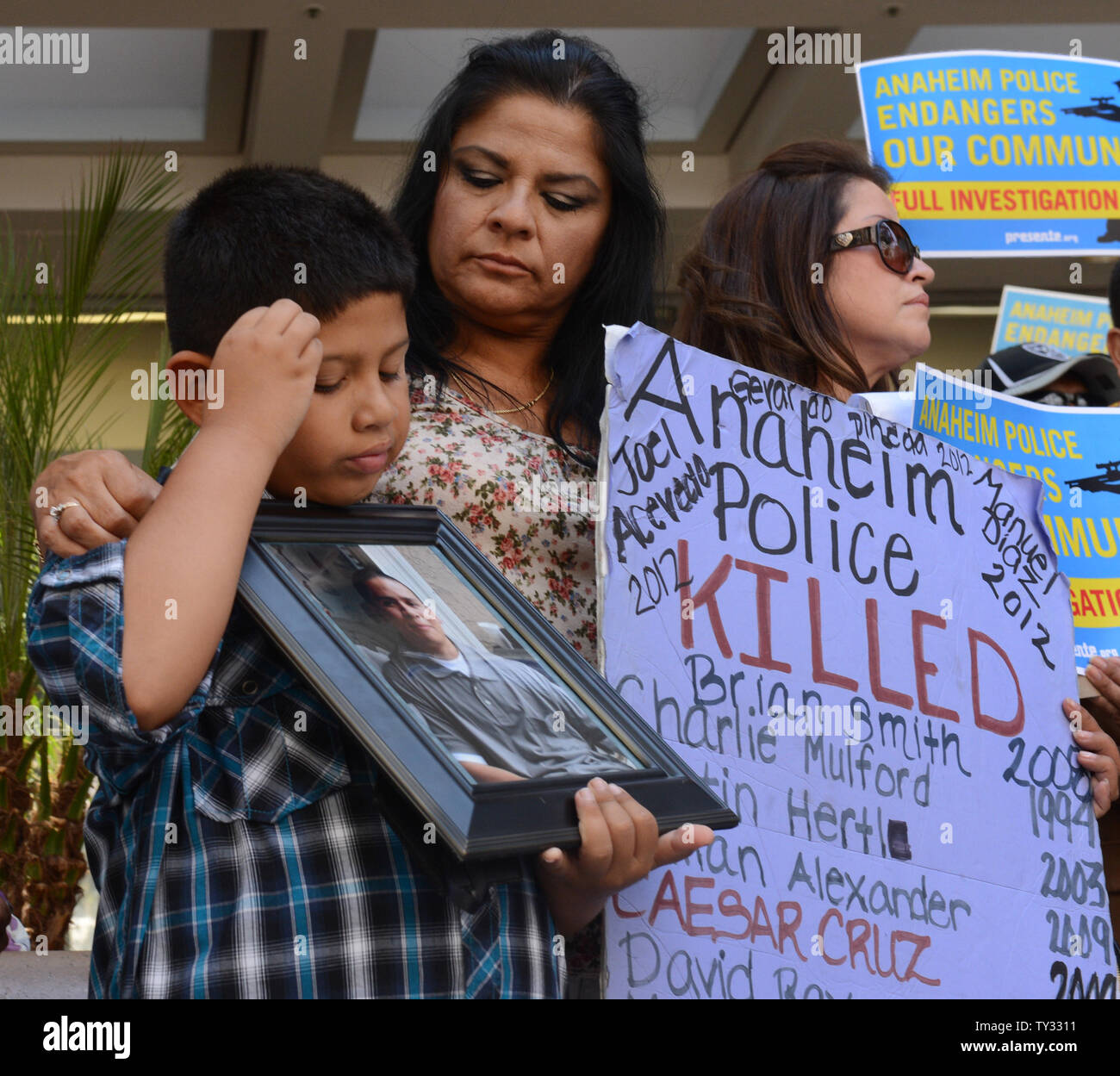 Jose Morales detiene una foto di Marcel Ceja, deceduto dopo una polizia-coinvolte le riprese, come egli si unisce a un gruppo di attivisti fuori Attorney General Kamala Harris' ufficio a Los Angeles il 30 luglio 2012, sollecitando il suo.indagare la polizia di Anaheim negli ultimi officer coinvolti tiri. UPI/Jim Ruymen Foto Stock