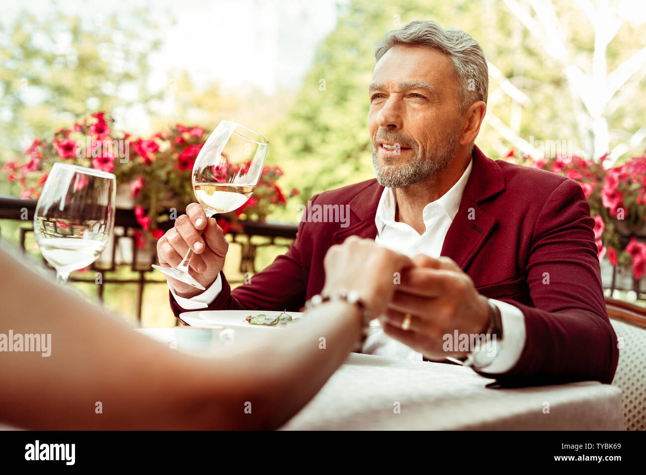 Barbuto grey-haired imprenditore avente una cena romantica con la moglie Foto Stock